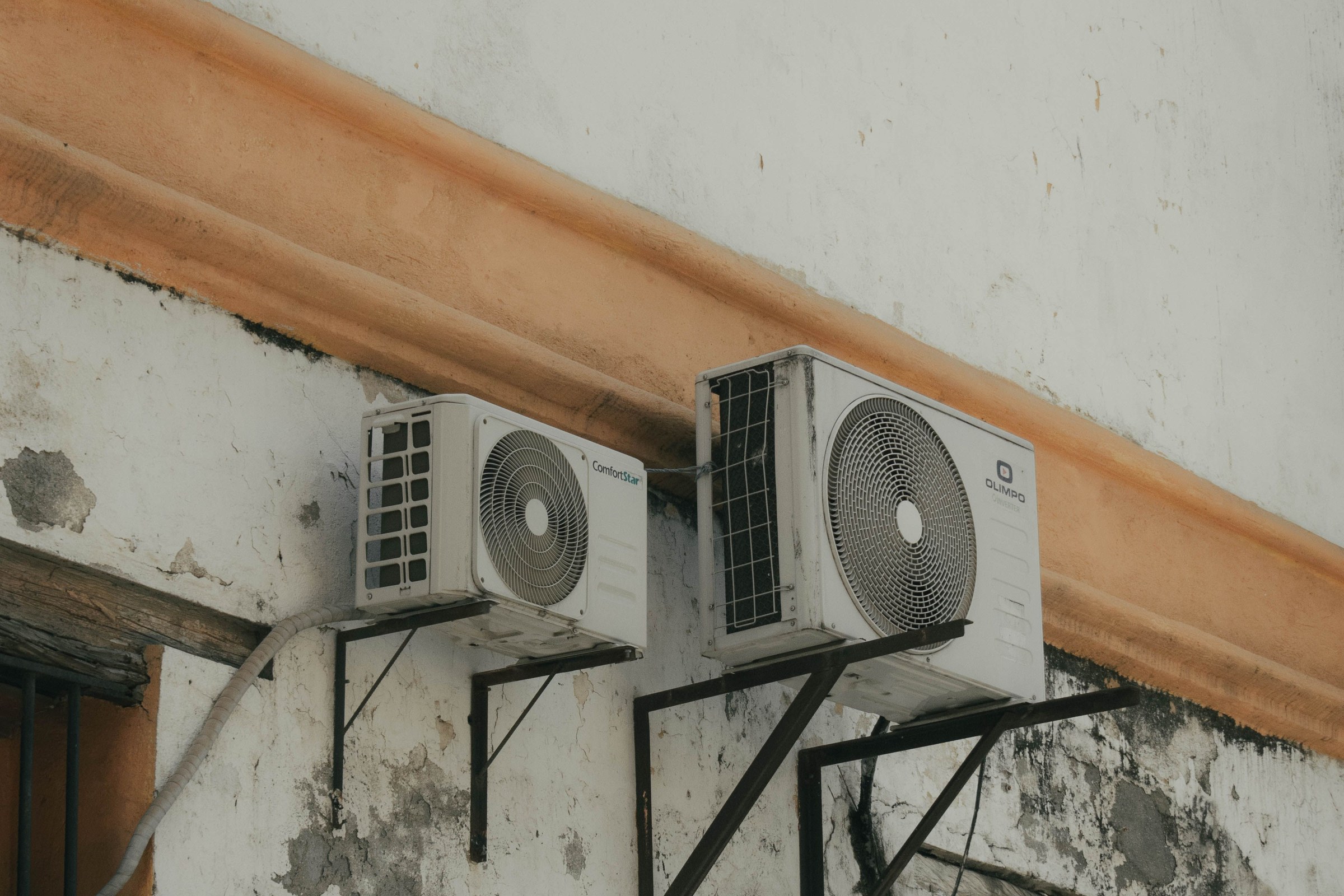 Outdoor condenser equipment on an exterior wall. A multi-split is two or more indoor units on one outdoor unit — this photo is not a two-outdoor multi.
